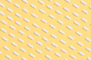 White Capsules On Yellow Background Desktop Wallpapers